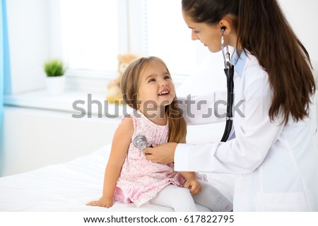 Doctor examining a little girl by stethoscope