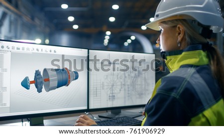 Inside the Heavy Industry Factory Female Industrial Engineer Works on the Personal Computer on the Turbine/ Engine Project in 3D Using CAD Program.