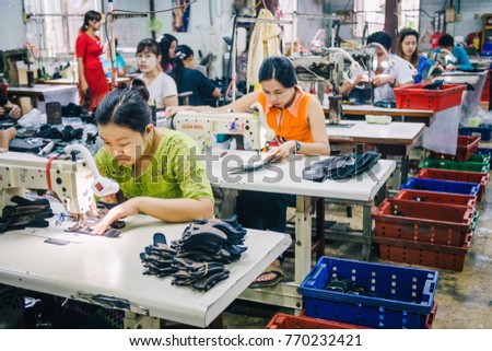 KANCHANABURI, THAILAND - JULY 22, 2017: Burmese Female Migrant Workers Sewing or Stitching Leather Shoes in footwear production line of factory in Sankhlaburi, Kanchanaburi, Thai-Burma border province