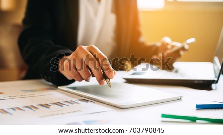 businessman working on project for analyzing company financial report balance statement with documents graphics at modern office space. Concept picture of business,economy, market,money and tax.