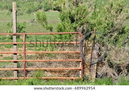 wire fence gate. simple wire lonely barbed wire fence and gate on the ranch waiting a cowboy on wire fence gate