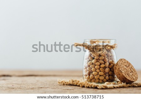 soy beans in bottle on wooden table