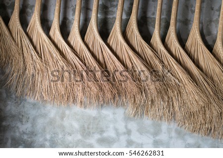 vietnamese brooms hanging on a wall