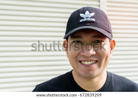 BANGKOK, THAILAND - JULY 2, 2017: Adidas logo on man cap. Adidas is German designer and manufacturer of sports clothing and accessories; largest in Europe and 2nd biggest in the world.