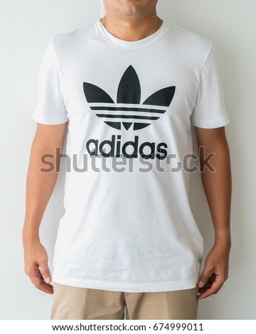 BANGKOK, THAILAND - JULY 2, 2017: Adidas logo on man T-shirt. Adidas is German designer and manufacturer of sports clothing and accessories; largest in Europe and 2nd biggest in the world.