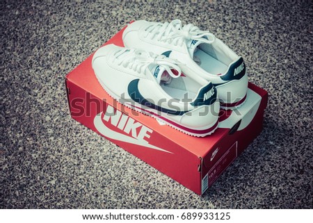 BANGKOK, THAILAND - JULY 2, 2017:Nike classic cortez white/midnight navy/gym-red with box. Nike, Inc. is an American multinational corporation that designs, develops, manufactures and sells.