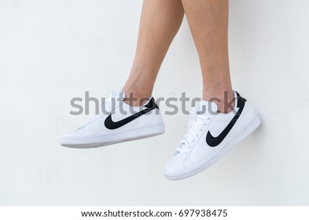 NAKHON PRATHOM, THAILAND - AUGUST 12, 2017:The woman wearing Nike tennis classic white/black shoes ,Nike, Inc. is an American multinational corporation that designs, develops, manufactures and sells tennis shoes.