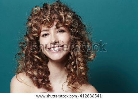 Stunning young woman with curly hair, portrait