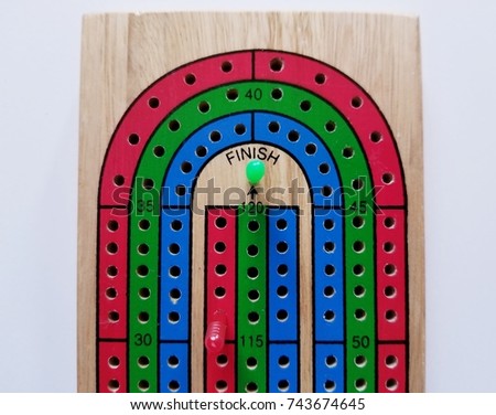High Angle Cribbage Board Winning Peg On White Background High Angle Cribbage Board Winning Peg On White Background