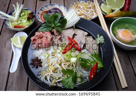 Preparing Vietnamese rice noodles, with beef and other materials