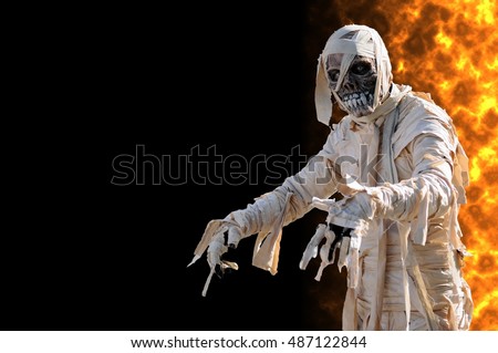 stock-photo-mummy-in-an-halloween-night-with-flames-on-the-right-487122844.jpg