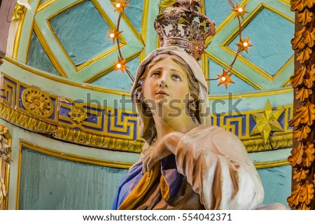 https://thumb7.shutterstock.com/display_pic_with_logo/1871453/554042371/stock-photo-blessed-virgin-mary-surrounded-by-stars-holding-hand-on-chest-554042371.jpg