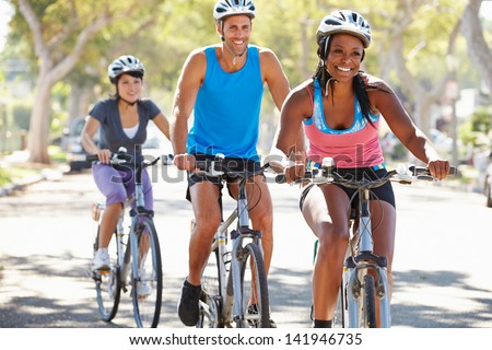 Group Of Cyclists On Suburban Street