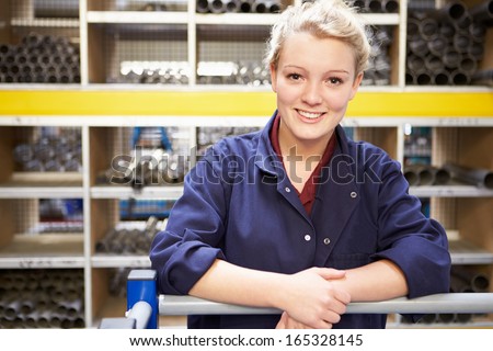 Portrait Of Female Engineering Apprentice In Store Room