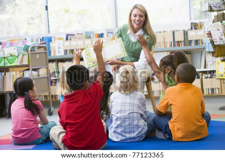 Students in class volunteering for teacher