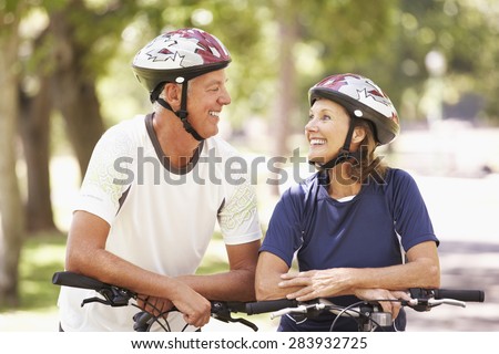 Portrait Of Mature Couple On Cycle Ride Through Park
