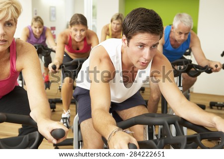 Group Taking Part In Spinning Class In Gym