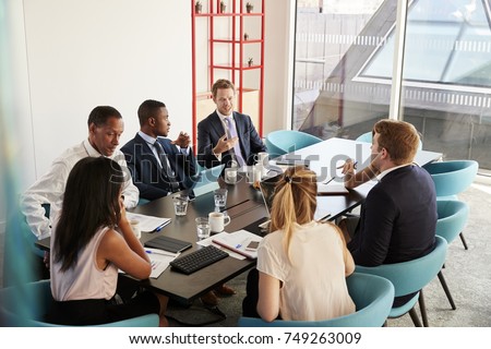 Work colleagues having a meeting in boardroom