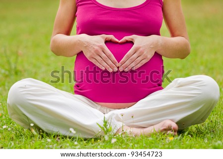 pregnant woman relaxing in the park