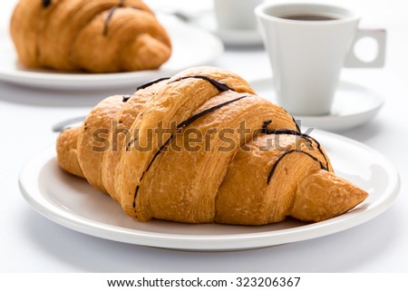 Fresh Chocolate Croissant And Coffee On A White Table Fresh Chocolate Croissant And Coffee On A White Table
