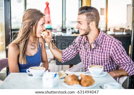 https://thumb7.shutterstock.com/display_pic_with_logo/1993499/631494047/stock-photo-couple-doing-breakfast-in-a-bar-coffeehouse-lovers-at-a-romantic-date-631494047.jpg