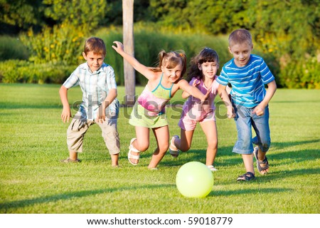 Boys and girls running towards ball