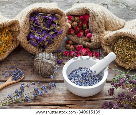 Healing herbs in hessian bags and mortar with dry lavender, herbal medicine.