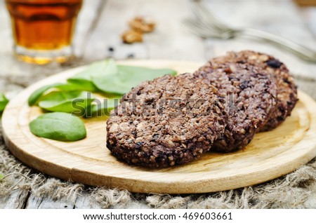 black beans brown rice walnut oat burgers with spinach. toning. selective focus