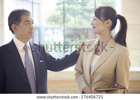 stock-photo-japanese-ceo-tapping-the-shoulder-of-the-secretary-176406725.jpg