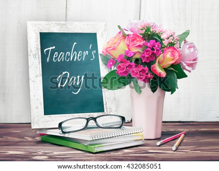 Teacher's day holiday greeting icon. Education knowledge day concept. Wooden chalk board frame and vase bouquet on table empty copy space.
