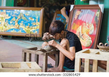 Bac Ninh, Vietnam - Sep 12, 2015: Junior craftsmen making copper handicraft products in traditional way (hand work) in Dai Bai village. Junior people are major labors in traditional works in Vietnam