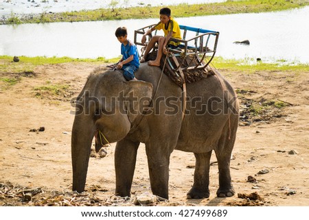 Dak Lak, Vietnam - Mar 29, 2016: Children ride elephant in Don village in Tay Nguyen, central highlands of Vietnam.