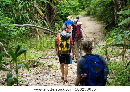 Quang Binh, Vietnam - June 17, 2016: Group of hikers walking on forest heading to Son Doong cave - the largest known cave passage in the world by volume in Quang Binh province, Vietnam