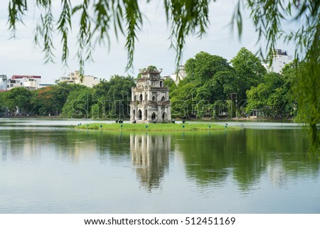 Hoan Kiem lake (Sword lake, Ho Guom) in Hanoi, Vietnam with willow branches on foreground