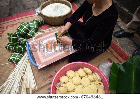 Making Chung cake by female craftsman closeup. Traditional Vietnamese New Year (Tet) food.