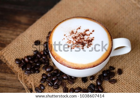 Mocha Coffee In The Wood Table With Bean On Sackcloth Mocha Coffee In The Wood Table With Bean On Sackcloth