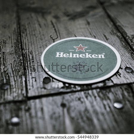 AMSTERDAM, HOLLAND - April 24, 2016.: Beer mats from Heineken Lager Beer in vintage background , it was first brewed by Gerard Adriaan Heineken in 1873