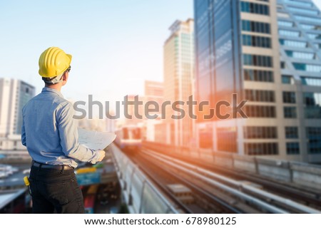 Close up engineers working on a building site holding a blueprints.Engineering and architecture concept