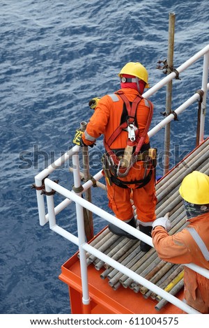 Construction workers installing scaffolding on site,Offshore construction platform for production oil and gas, Oil and gas industry and hard work