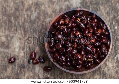 Black beans in wooden bowl. Top view. Copy space