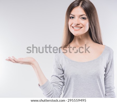 https://thumb7.shutterstock.com/display_pic_with_logo/2181548/295559495/stock-photo-copy-space-on-her-hand-beautiful-young-smiling-woman-holding-a-copy-space-and-smiling-while-295559495.jpg