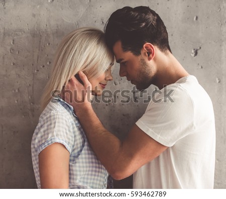 https://thumb7.shutterstock.com/display_pic_with_logo/2181548/593462789/stock-photo-romantic-young-couple-is-touching-their-foreheads-on-concrete-wall-background-593462789.jpg