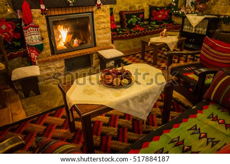 Image of fire burning in a fireplace decorated in Christmas style