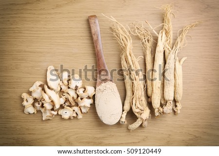 Korean ginseng powder,Dry Ginseng Roots on wood background - vintage filter.