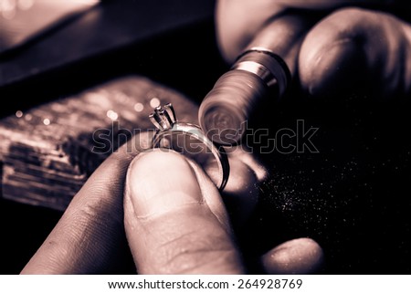 Craft jewelery making. Ring polishing. Macro shot. Monochrome cream tone. Black and white photography.