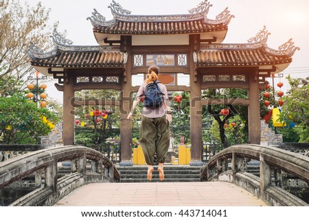 Woman jumping on the bridge in Hoi An city, Vietnam
