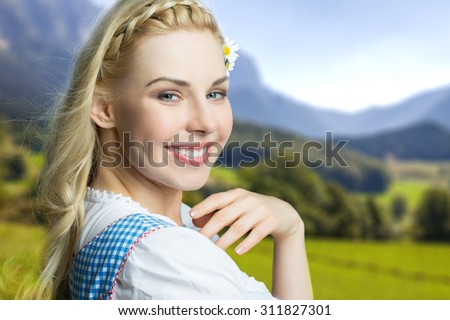 https://thumb7.shutterstock.com/display_pic_with_logo/2234105/311827301/stock-photo-beautiful-woman-in-a-traditional-bavarian-dirndl-311827301.jpg