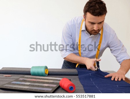 Tailor man working in his tailor shop