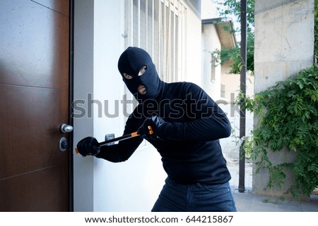stock-photo-burglar-trying-to-force-a-door-lock-using-a-crowbar-644215867.jpg