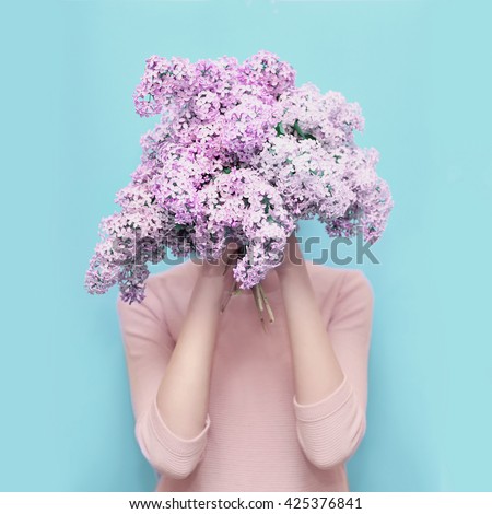 http://thumb7.shutterstock.com/display_pic_with_logo/2273876/425376841/stock-photo-woman-hiding-head-in-bouquet-lilac-flowers-over-colorful-blue-background-425376841.jpg